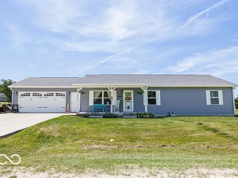 Front exterior of 3708 Megan Ct in Spencer, Indiana: a gray ranch home with an attached two car garage.
