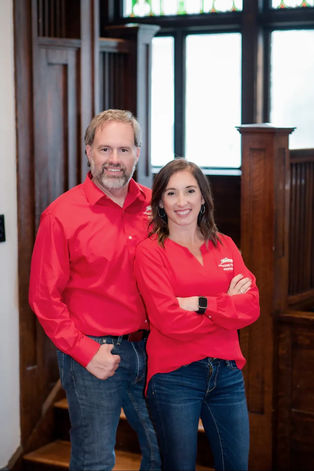 Rob Ranard and Samantha Carver of The HOME TEAM Properties standing together with arms crossed.